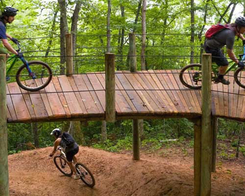 Mountain bikers on wooden platforams and bridges along the Fire Mountain Trail System